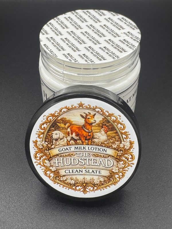 The Hudstead Clean Slate goat milk lotion in a black 4 oz jar with the lid label showing