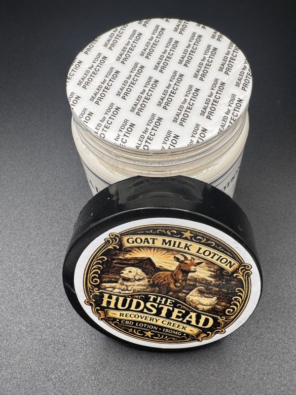 The Hudstead Recovery Creek 150 goat milk lotion in a black jar with a gold lid label